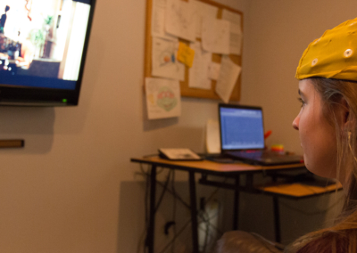 Young female patient watched a move while connected to brain mapping as part of neurofeedback